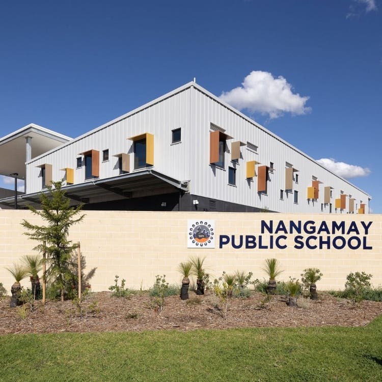 Image of front of school with school name displayed